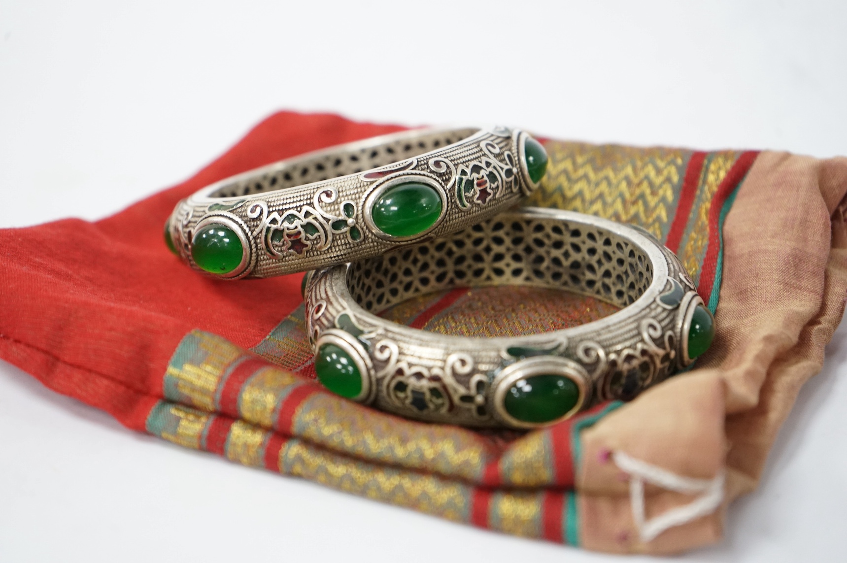 A pair of Mongolian metal and enamel bangles, 8.5cm diameter. Condition - good